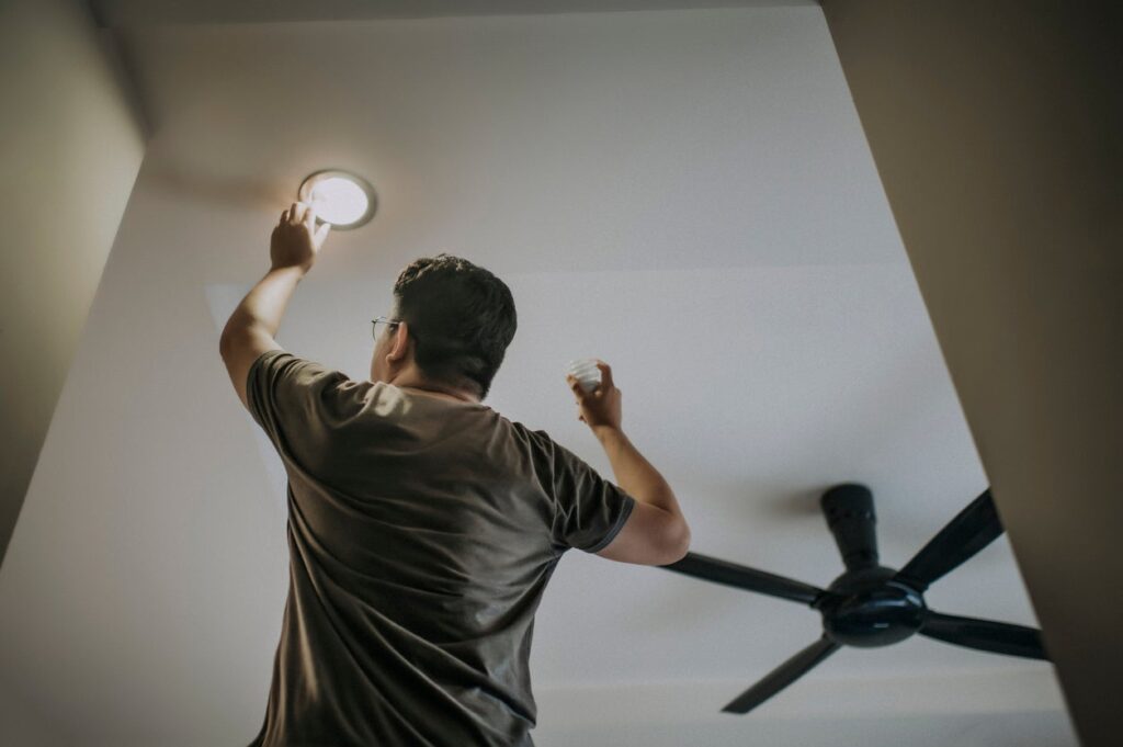 a person adjusting ceiling LED lights