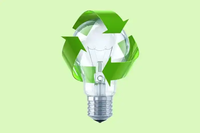 recycling symbol on a bulb in front of a green background