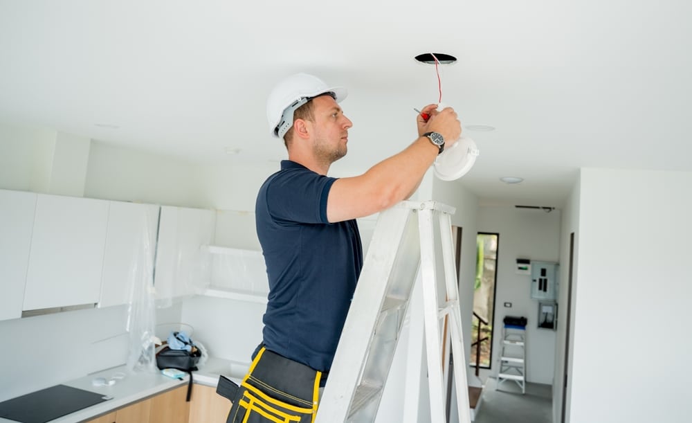 Technician Is Installing An Led Spotlight In The Ceiling