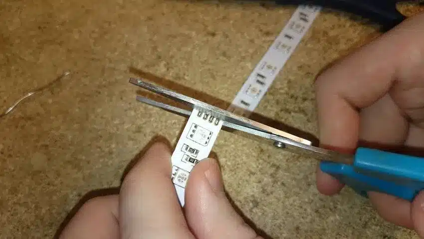 person cutting the LED strip lights