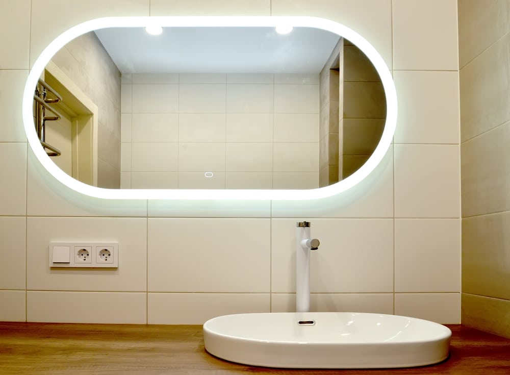 Large Oval Mirror With Built in Led Lighting In The Bathroom