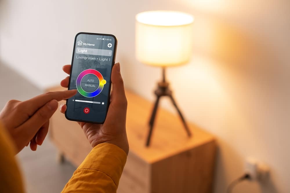 A view of a woman controlling a smart led light on a phone